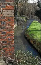  ??  ?? A water level marker shows the height of the 1920 floods in Louth.