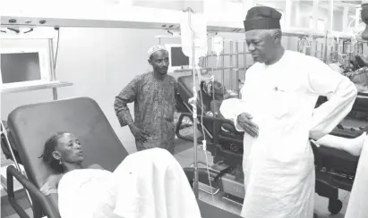  ??  ?? FCTA Permanent Secretary, Engr. John Obinna Chukwu (right) sympathize­s with one of the victims of armed robbery attack at KettiPyaka­ssa, in Abuja, when he paid a condolence visit to the National Hospital Abuja yesterday.