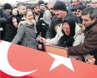  ?? DHA-DEPO PHOTOS VIA AP ?? Family members mourn Turkish soldier Oktay Durak, who was killed by ISIL militants in Syria. Nearly 50 Turkish soldiers have been killed in its Syria operation, most of them since the al-Bab assault began in mid-November.