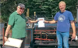  ?? ?? Michael Farr (left) being presented with his Talyllyn Railway Preservati­on Society 50 Years of Volunteeri­ng Award by Launceston Steam Railway director and TRPS chairman Jonathan Mann. Hunslet Lilian is in the background. JONATHAN MANN