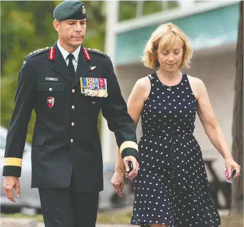  ?? JUSTIN TANG / THE CANADIAN PRESS ?? Maj.-gen. Dany Fortin walks with his wife Madeleine Collin as he arrives at the Gatineau police station Wednesday.