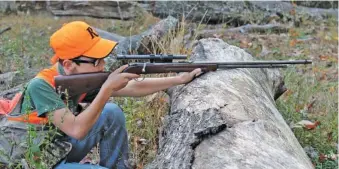  ?? PHOTO CONTRIBUTE­D BY LARRY CASE ?? Jack Ellis takes aim with a Remington Model 34 .22 rifle. The Model 34 is a good option for squirrel hunting, which, like the .22 itself, is a good way to introduce young people to the sporting pursuits of the outdoors.