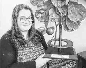  ?? CONTRIBUTE­D ?? Chantelle Cormier holds her Science Champion Discovery Award for bringing science education into the community. The 2020 awards were presented virtually on Nov. 26 due to COVID-19.