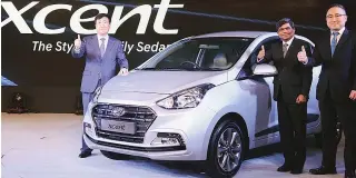  ??  ?? Hyundai India MD & CEO Y K Koo (left) and other company officials at the launch of a new compact sedan, Xcent, on Thursday. The firm aims to sell 60,000 units in a year, and the car comes in the range of ~5.38 lakh and ~8.41 lakh.