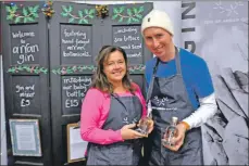  ?? 01_B51gin ?? Stuart Fraser and Linda Tudhope show off the new 20cl mini bottles at Santa’s Sparkle last month.