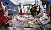  ?? An elderly patient boards a medical evacuation train run by Doctors Without Borders at the train station in Pokrovsk in eastern Ukraine on Sunday to travel to hospitals away from the fighting. FRANCISCO SECO/AP ??