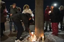  ?? SCOTT GARDNER, THE HAMILTON SPECTATOR ?? Above: Holly Hamilton’s car is towed from 95 Barlake Avenue in east Hamilton. Left: Candles are put down by friends at a spot at Fairfield Avenue North and Barton Street East Wednesday night during a vigil for Holly Hamilton. It is near where her ex-boyfriend lived. He has been arrested.