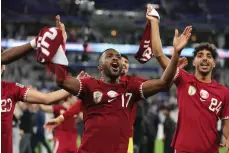  ?? Getty Images ?? Qatar players celebrate after beating Iran