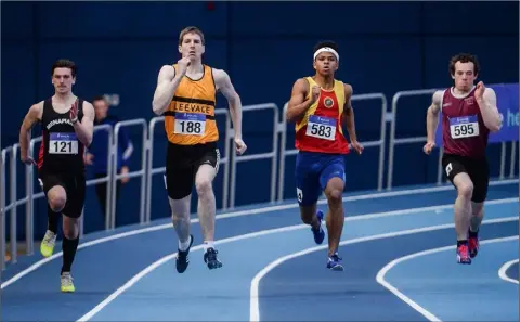  ??  ?? Conor Wilson of Menapians (left) competing in the Senior men’s 200m in the National Indoor Arena on Sunday.