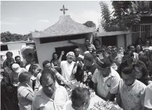  ?? THE ASSOCIATED PRESS ?? A family member laments the death of 64-year-old Reynalda Matus as mourners prepare to bury her Saturday at the Miercoles Santo Cemetery in Juchitan, Oaxaca state, Mexico. Matus was killed when the pharmacy where she worked nights collapsed during...