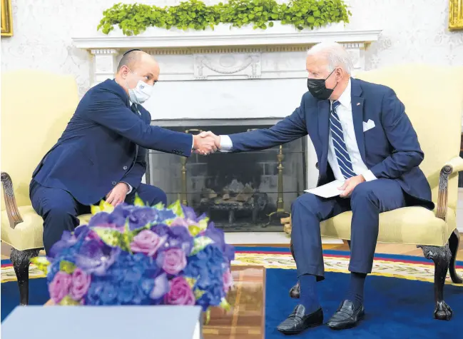  ?? EVAN VUCCI/AP ?? President Joe Biden, right, shakes hands with Israeli Prime Minister Naftali Bennett as they meet in the Oval Office of the White House on Aug. 27 in Washington.