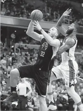  ?? Manuel Balce Ceneta Associated Press ?? THE CLIPPERS’ Blake Griffin, who scored a team-high 26 points, is fouled by Washington’s Markieff Morris as he goes up for a shot.