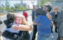  ?? AP PHOTO ?? Susan Adieh, left, cousin, and other family members of Noor Salman receive hugs from friends Friday after a jury found Salman not guilty on all charges at the Orlando Federal Courthouse, in Orlando, Fla.