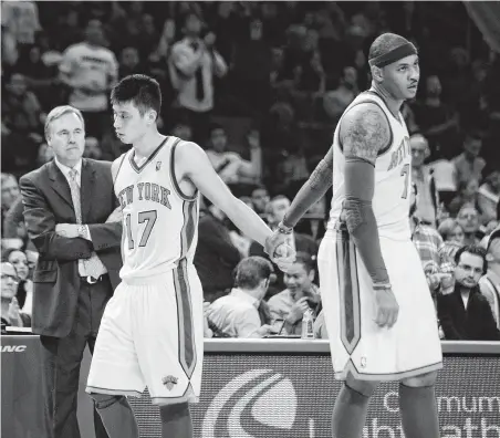  ?? Bill Kostroun / Associated Press ?? Mike D’Antoni, left, then in charge of the Knicks, had a troubled 2011-12 season and eventually stepped down when he could not persuade Carmelo Anthony, right, to play in the coach’s preferred style. Future Rocket Jeremy Lin, center, also was on that team.