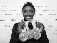  ?? Associated Press ?? BILES’ BLING — Simone Biles shows her five gold medals at the Gymnastics World Championsh­ips in Stuttgart, Germany, on Oct. 13. Biles is the 2019 AP Female Athlete of the Year.