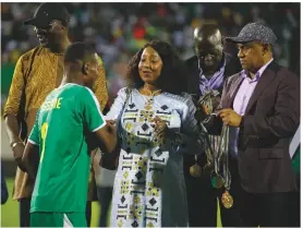  ??  ?? Rewards...Ahmad (above right) and Fatma Samoura hand out medals at last year’s WAFU Cup of Nations