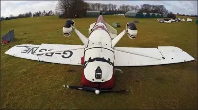  ??  ?? Havoc: A small aircraft was blown upside down at Popham Airfield, near Basingstok­e, Hampshire