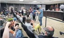  ??  ?? Adriana Law speaks to the crowd at an Oklahoma County Jail Trust forum Aug. 19. Laws and Mark Faulk, right, are plaintiffs in a lawsuit recently filed against the trust. [DOUG HOKE/ THE OKLAHOMAN]