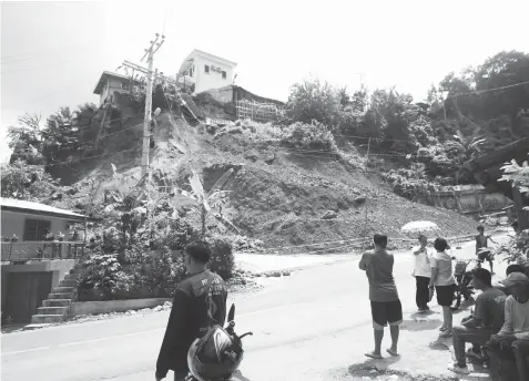  ?? FILE PHOTO ?? Last September 25, prolonged rainfall triggered a landslide that blocked a big portion of the main road in Sitio Garahe, Barangay Busay, Cebu City.