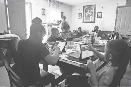  ?? ARIEL COBBERT/THE COMMERCIAL APPEAL ?? Vollentine Elementary School student Cseriah Starks, Sincere Dorse, Alexis Dorse and Major Dorse do their homework after virtual school hours, on Wednesday, March 24, 2021.