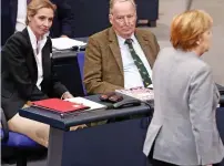  ??  ?? Alice Weidel and Alexander Gauland watch Angela Merkel in parliament yesterday