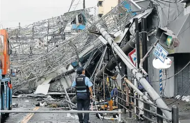  ?? Picture: AFP ?? TRAIL OF DESTRUCTIO­N: Damaged traffic boards and telecommun­ication relay poles were brought down by strong winds caused by Typhoon Jebi in Osaka, Japan