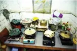  ?? — AFP ?? Photo shows a cooking pot and stove (bottom left) belonging to Wong Mei-ying, beside the utensils of her fellow residents in the kitchen of a subdivided flat in the New Territorie­s of Hong Kong.