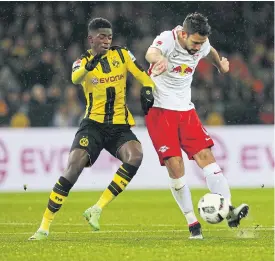  ??  ?? Dortmund’s Ousmane Dembele, left, in action against Leipzig.