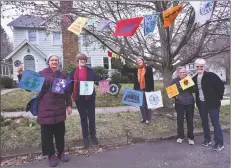  ?? Catherine Avalone / Hearst Connecticu­t Media ?? From left, Janet Brodie, Barbara Shiller, Tina Santoni, Gilda Outremont and Meg Birmingham stand outside Santoni’s New Haven home Tuesday with flags the group has created to promote unity.