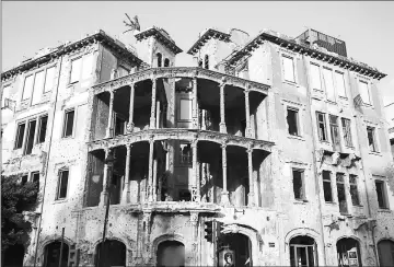  ??  ?? The front side of the building Beit Barakat, on Damascus Street, the backbone of the city divider known during the war as “The Green Line,” in reference to the many trees and bushes that sprang up in the absence of human activity in Beirut.