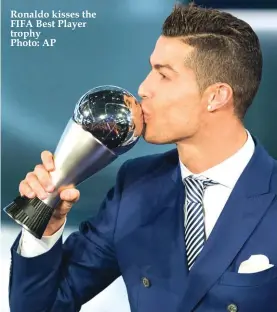  ??  ?? Ronaldo kisses the FIFA Best Player trophy Photo: AP