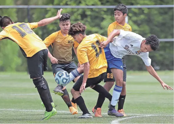  ??  ?? Gatlinburg­h-Pittman’s Ricardo Turcois tries push past a crowd of MBA’s players as Franklin Martinez (11) blocks his pass during the Class A boys soccer quarterfin­als at Spring Fling in Murfreesbo­ro. JIM WEBER/THE COMMERCIAL APPEAL