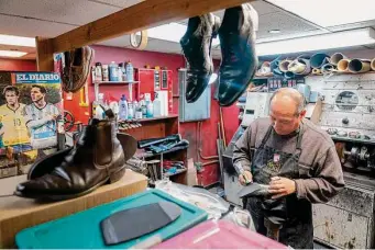  ?? Mary Altaffer/Associated Press ?? An employee repairs women’s shoes at the Alpha Shoe Repair Corp. last month in New York.