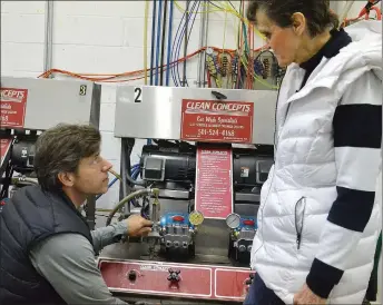  ?? TIMES photograph by Annette Beard ?? Mary Wright, right, shows new operator Shane Perry the inner workings of the car wash.