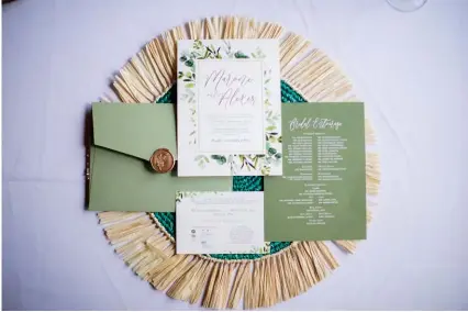  ?? ?? The stationery also featured the same cream and moss green palette, along with a delicate illustrati­on of fresh foliage on the border and a gold wax seal.