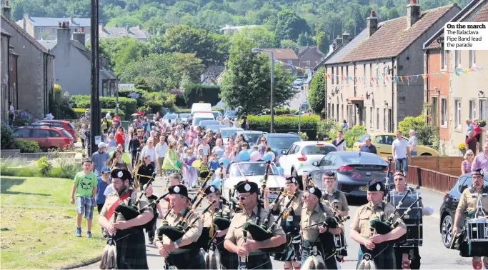  ??  ?? On the march The Balaclava Pipe Band lead the parade