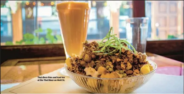  ?? ?? Thai disco fries and iced tea at the Thai Diner on Mott St.