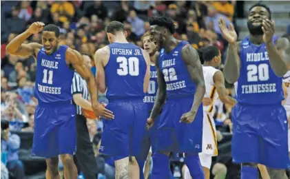  ?? THE ASSOCIATED PRESS ?? Middle Tennessee State players react during the second half of their NCAA basketball tournament win over Minnesota on Thursday.