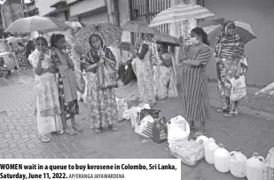  ?? AP/ERANGA JAYAWARDEN­A ?? WOMEN wait in a queue to buy kerosene in Colombo, Sri Lanka, Saturday, June 11, 2022.