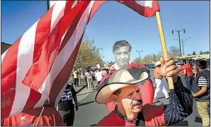  ?? AP file photo ?? Guadalupe Suarez of Santa Rosa, Calif., joins United Farm Workers supporters participat­ing in the annual Cesar Chavez/United Farm Workers march. On Monday, the California Supreme Court ruled in favor of organized workers in a lawsuit filed by the union...