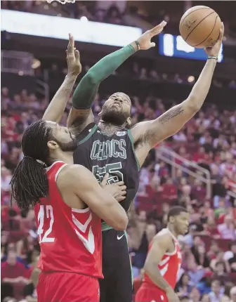  ?? AP PHOTO ?? BATTLE IN THE MIDDLE: Celtics center Greg Monroe shoots over Rockets center Nene during the second half last night in Houston.
