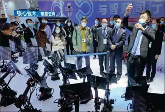  ?? GAO ERQIANG / CHINA DAILY ?? A ZTE employee conducts a 5G- enabled, artificial intelligen­ce- powered orchestra on Monday at the ongoing World Internet Conference in Wuzhen, Zhejiang province.