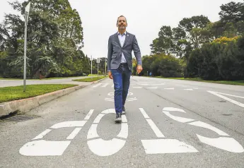  ?? Gabrielle Lurie / The Chronicle ?? Jeffrey Tumlin, head of the San Francisco Municipal Transporta­tion Agency, walks on JFK Drive in Golden Gate Park. Tumlin, who has worked in cities all over the world, says San Francisco is the most conservati­ve when it comes to transit and housing.