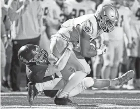  ?? ANDREW NELLES/THE TENNESSEAN ?? MBA’S Aiden Conley tackles Christian Brothers’ Bryce Dailey during the third quarter at Montgomery Bell Academy on Friday.