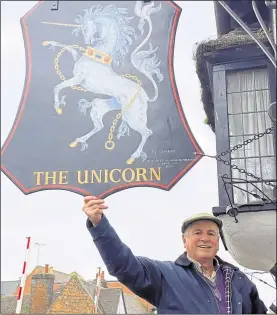  ??  ?? Alderman Richard Parkinson hanging the recently-restored pub sign, which had been damaged by recent storms