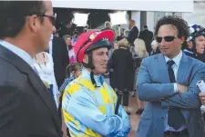  ??  ?? Jockey Darren Gauci talks to trainers Mathew Ellerton (left) and Simon Zahra, who have high hopes for today’s Caulfield meeting