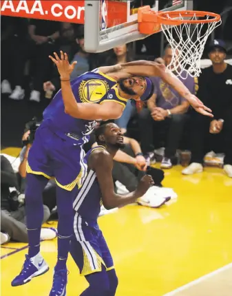  ?? Chris Carlson / Associated Press ?? Warriors center JaVale McGee ducks under the basket going after a rebound during the first half of the overtime victory against the Lakers in Los Angeles.