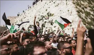  ?? Ariel Schalit / Associated Press ?? Mourners carry slain Al Jazeera veteran journalist Shireen Abu Akleh’s casket from her funeral in the Old City of Jerusalem to the cemetery on Friday.