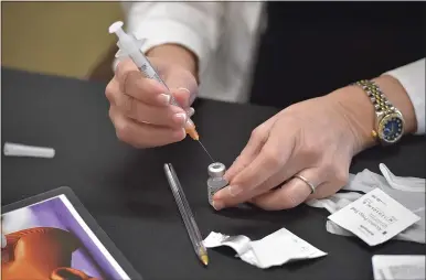  ?? MEDIANEWS GROUP — DAILY TIMES ?? CVS pharmacist Gina Glancy draws a single dose of the Pfizer BioNTech COVID-19vaccine during a clinic in East Goshen. Chester County officials are encouragin­g teens 16and older to get vaccinated.