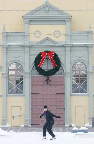  ?? WAYNE CUDDINGTON ?? Laura Markle takes advantage of the ice pad at Lansdowne Park to go for a spin on the blades against the backdrop of the Aberdeen Pavilion.